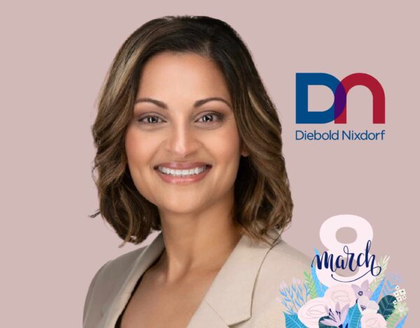 Professional woman smiling in front of a pink background, with the Diebold Nixdorf logo and "8 March" text with floral decorations in the bottom right corner.